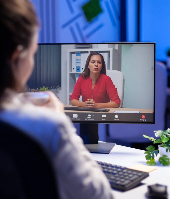Professional attending evening video conference call with colleague on screen